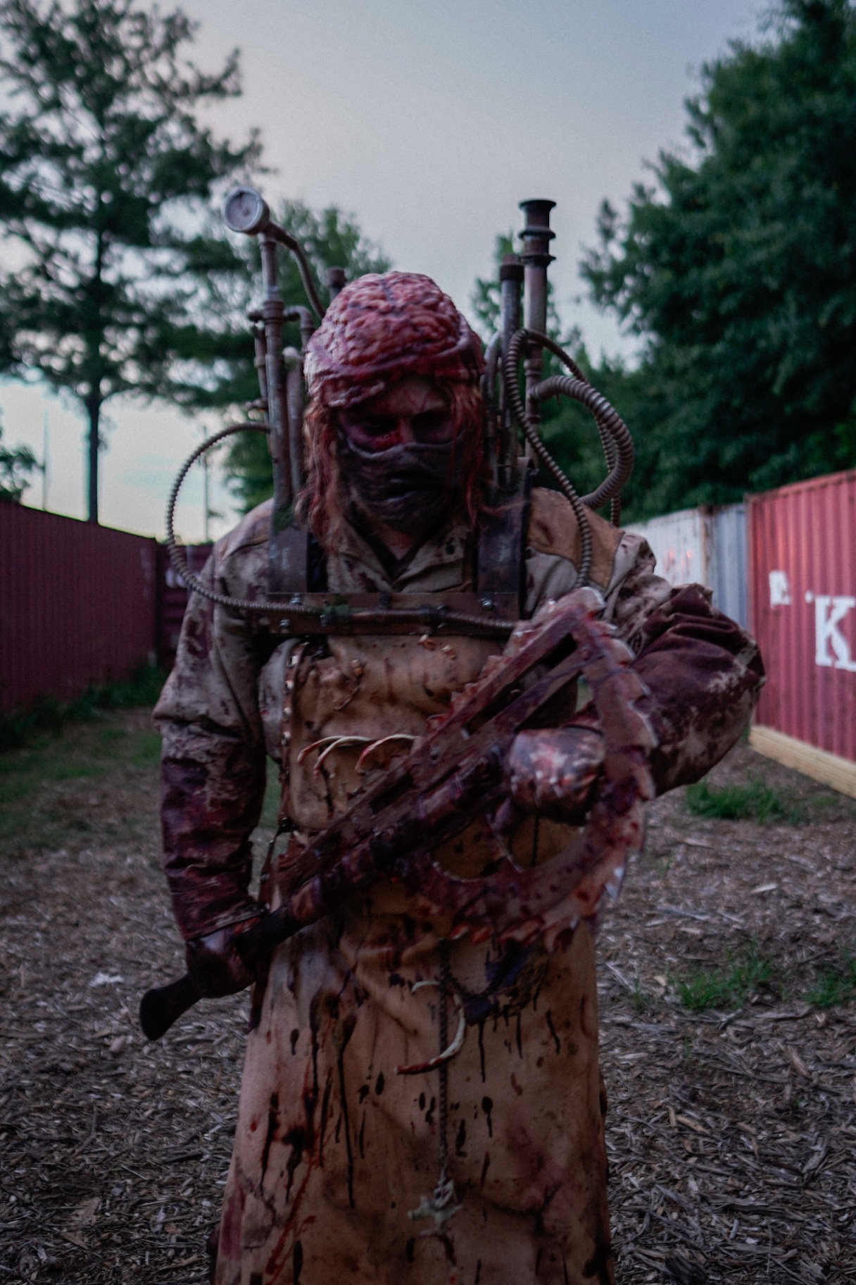 Mortem — bloodied figure with pipe apparatus and cleaver